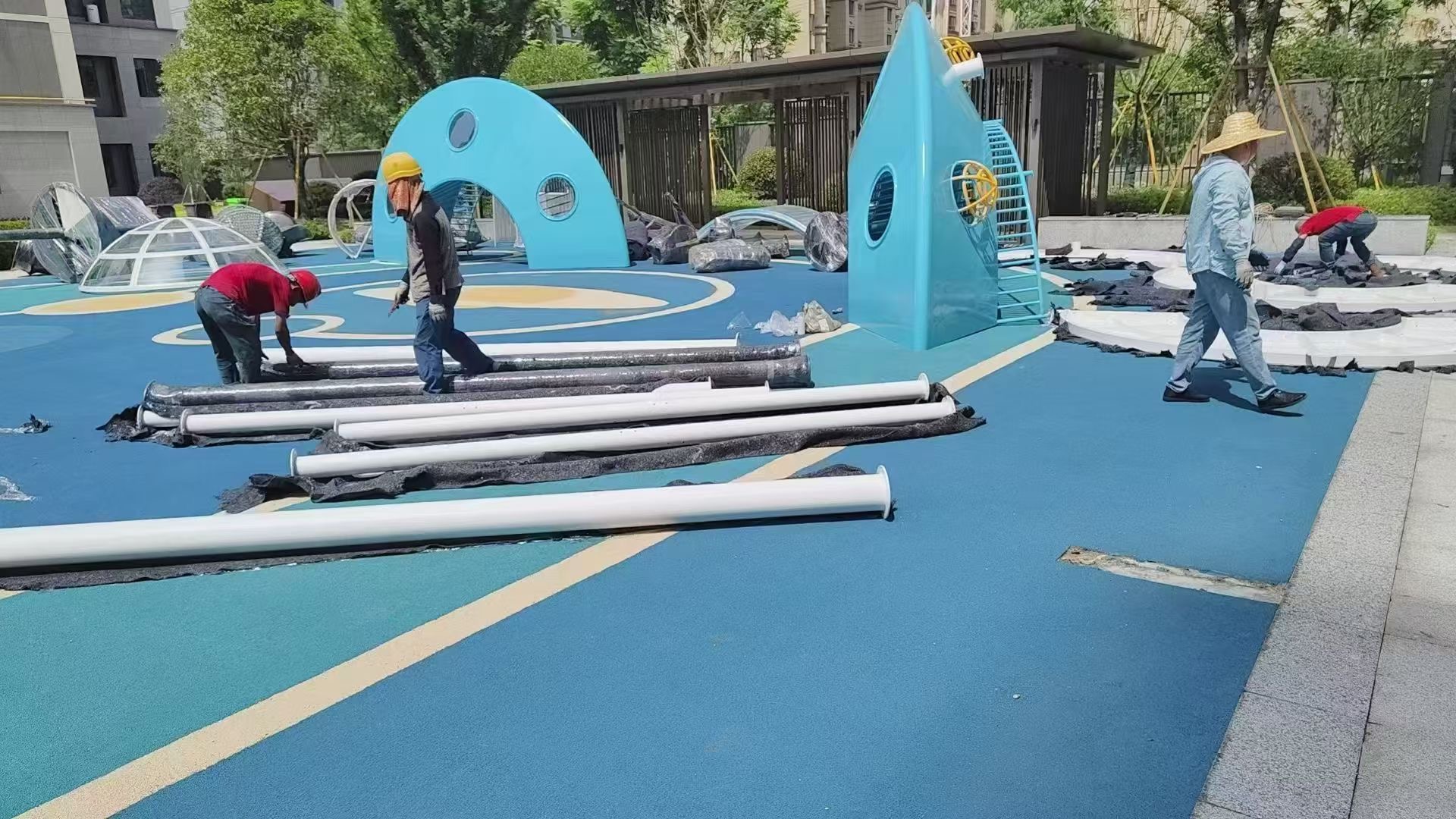 Assembly phase of large-scale play dome on site Crane lifting fiberglass UFO structure into position