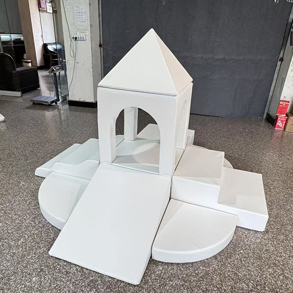 white soft play castle with slide and blocks