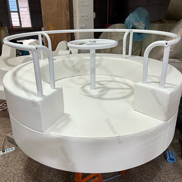 Indoor soft carousel for toddlers with round padded seats and safety handle