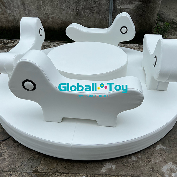 White soft play animal carousel with four ride-on seats for toddlers