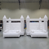 Side-by-side white bounce houses for commercial hire