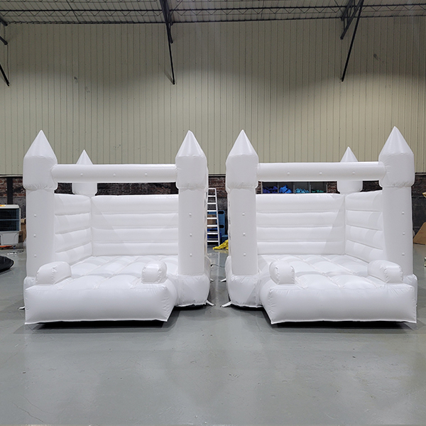 Side-by-side white bounce houses for commercial hire