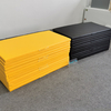 Stacked yellow and black soft play mats for kids zone