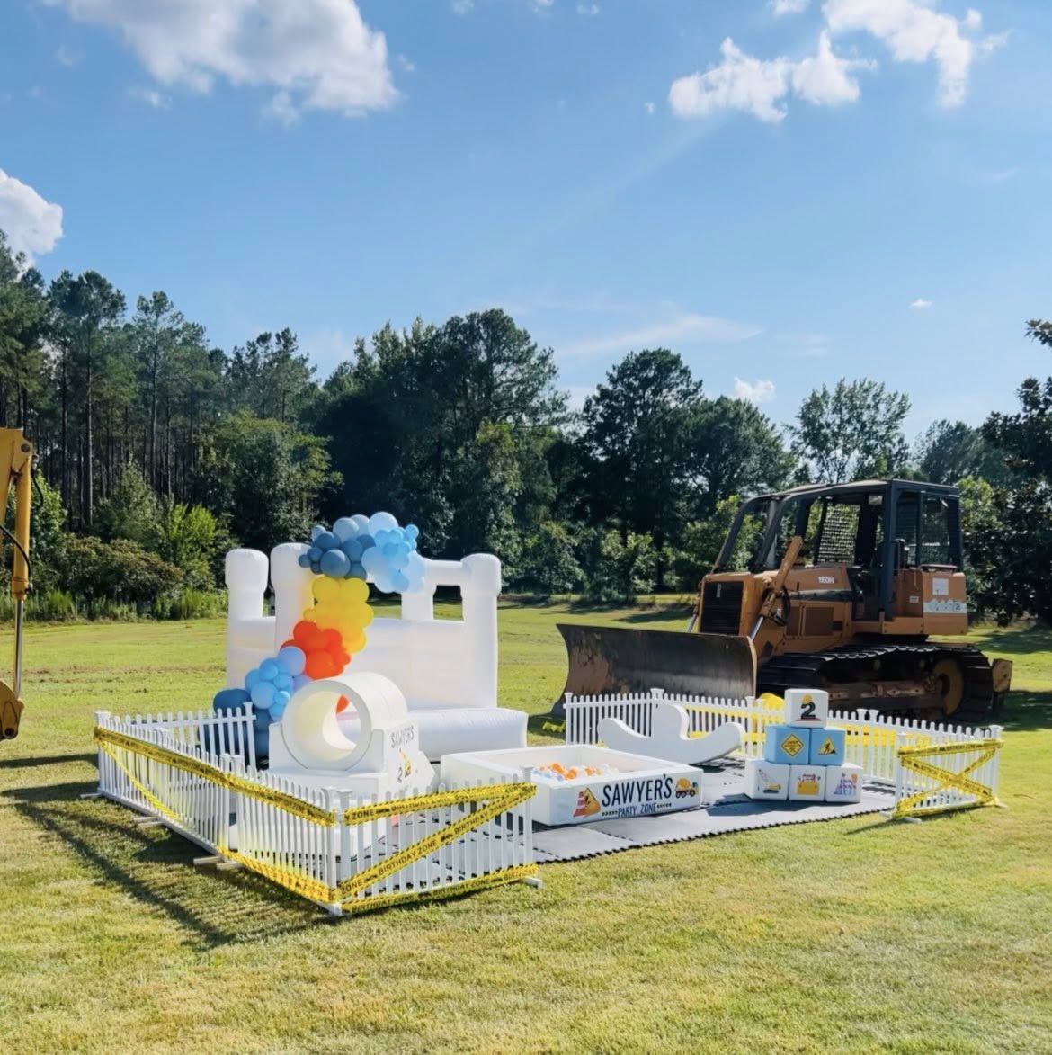White Inflatable Bounce House with Ball Pit and Construction Theme Party Setup