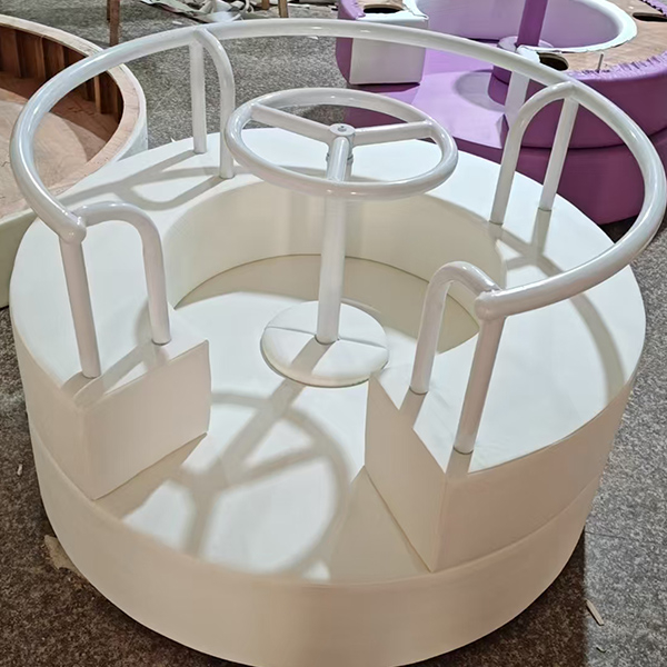 White soft play merry go round with steering wheel for kids indoor playground