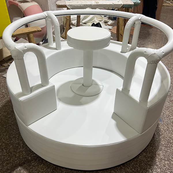Commercial soft play spinning ride for children with protective handles and seat