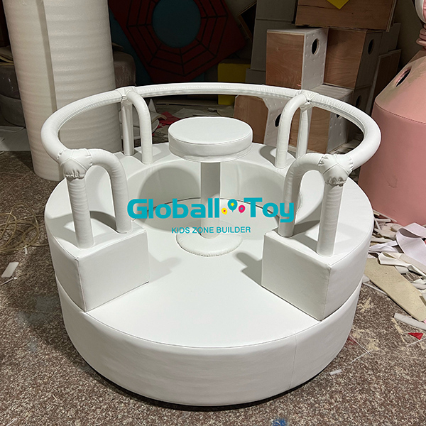 Round soft play merry go round with padded safety rail for toddler indoor playground