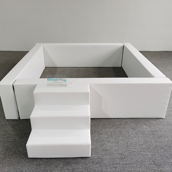 White foam ball pit with padded floor and soft walls