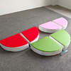 Fruit-shaped soft cushion playmat in red, green, and pink for indoor kids' play areas