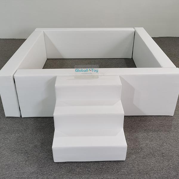 Side view of white soft play fence with climbing steps
