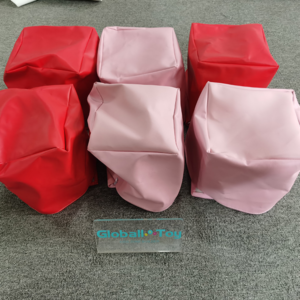 Red and pink soft play bags for sensory games and indoor playgrounds