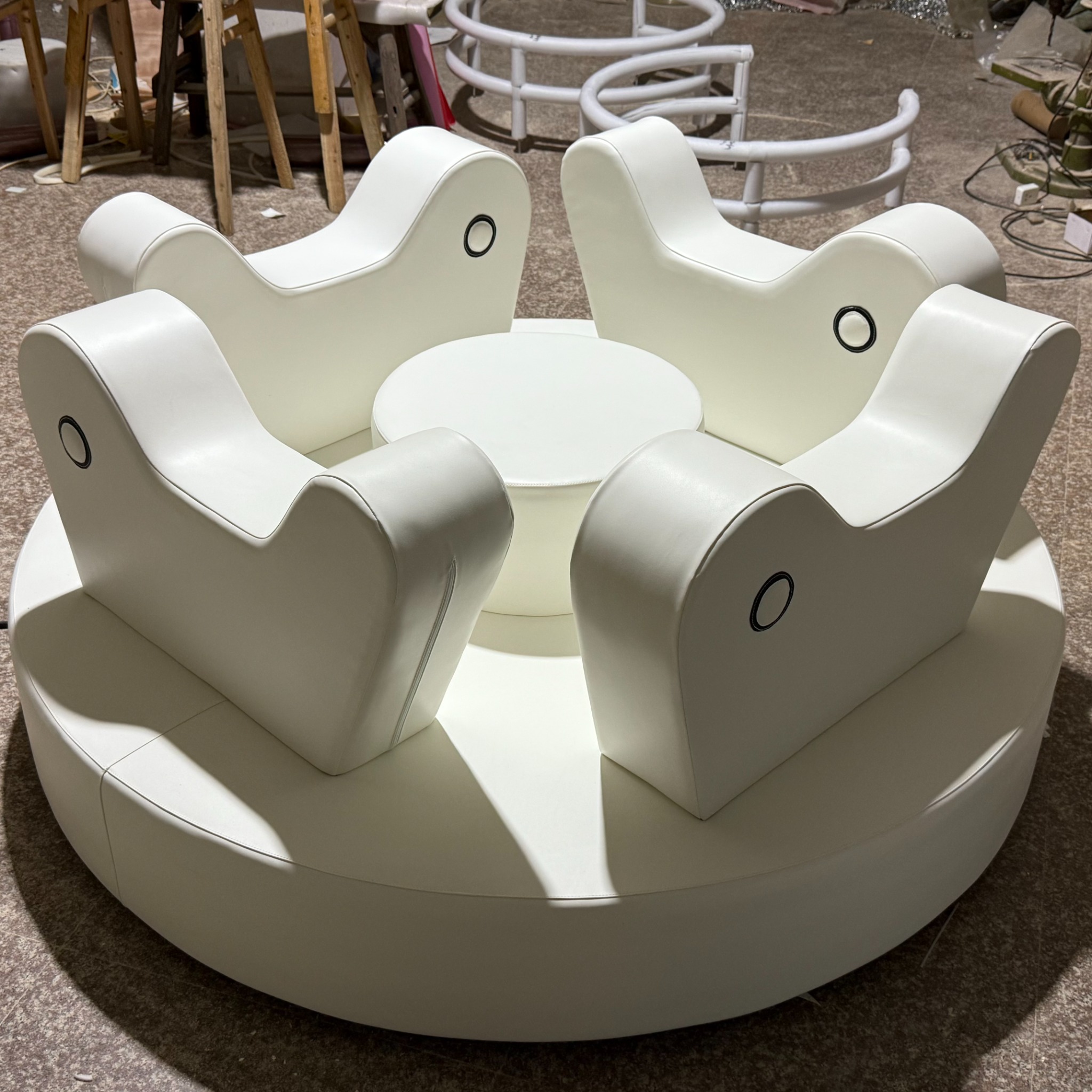 White soft play roundabout for kids with four seats and central hub