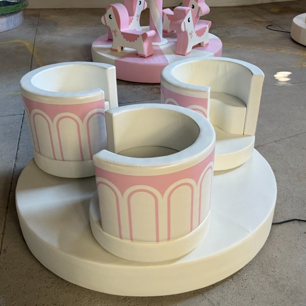 Pastel pink soft play spinning ride for toddler play area
