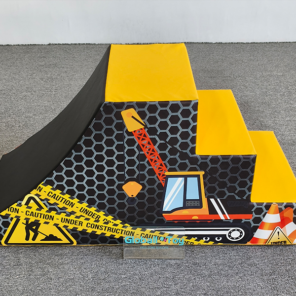 Yellow toddler climbing soft stairs with construction graphics