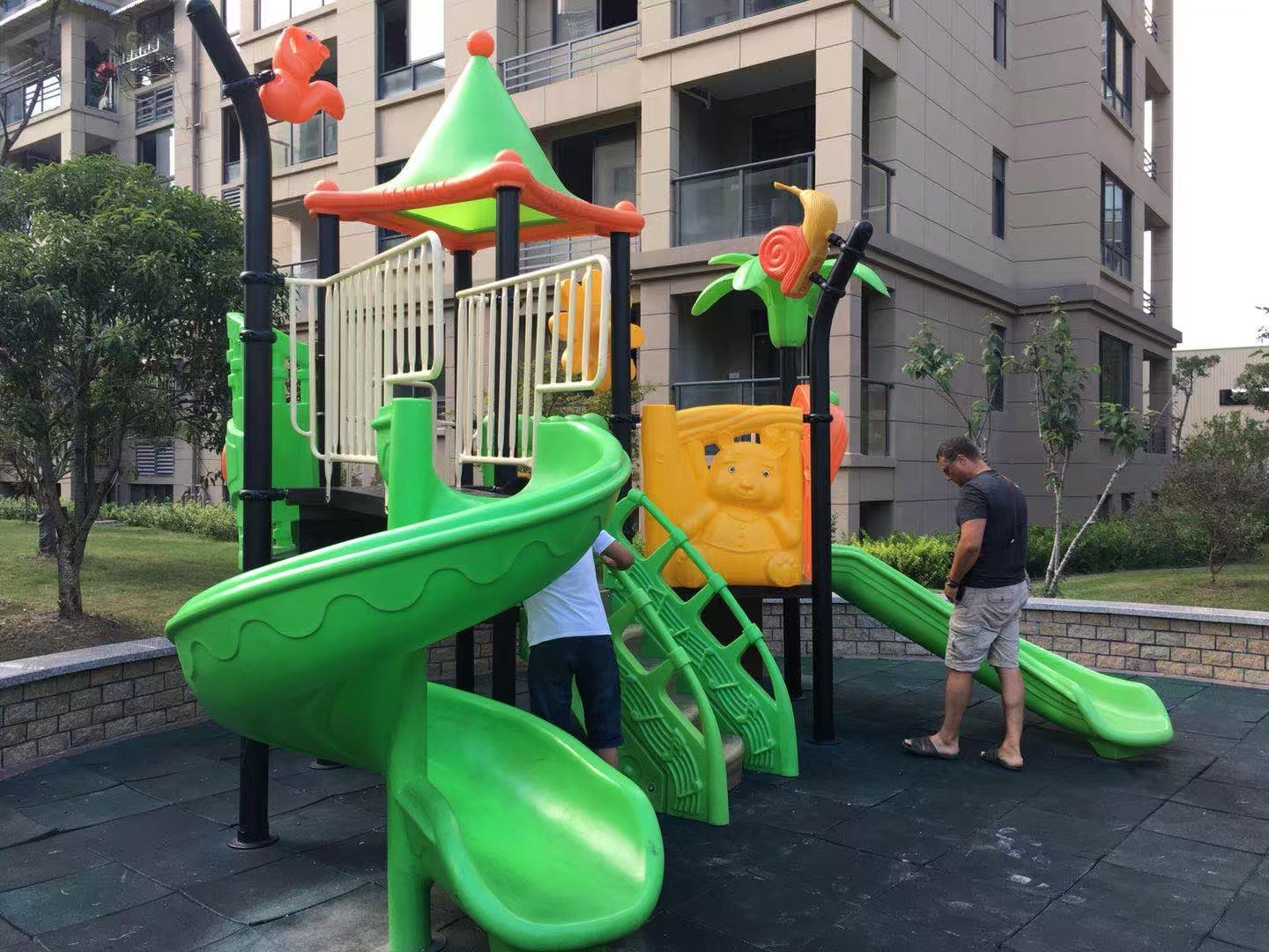 Spiral plastic slide structure in residential green space