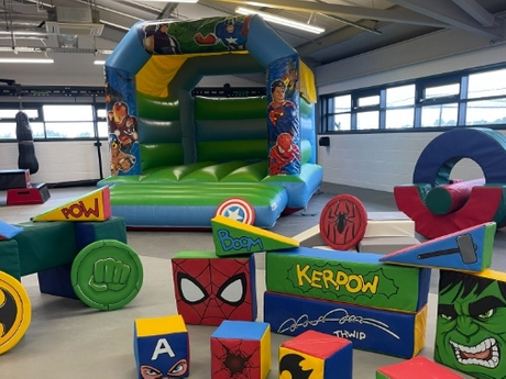 superhero-themed inflatable bounce house with colorful soft play blocks_504_378.png