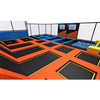 custom trampoline park structure with interconnected jump zones and foam cube pit