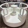 White soft play equipment roundabout indoor playground.